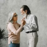 Charming elderly couple dancing indoors, embodying love and togetherness. Bright and heartwarming moment.