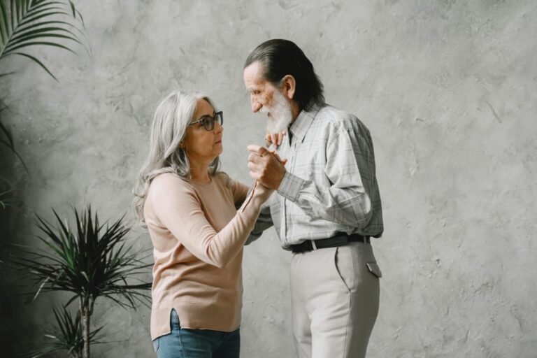 Charming elderly couple dancing indoors, embodying love and togetherness. Bright and heartwarming moment.
